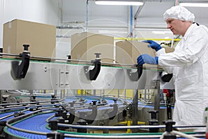 worker in white apron at packing line