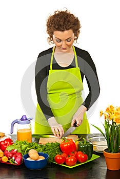 Worker woman cutting green onion