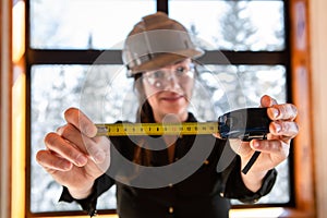 Worker woman holding a tape measure