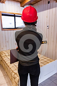 Worker woman at interior work rear view