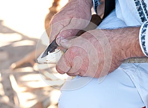 Worker wood craftsman, an artisan detail, tradition and old work. Romanian artisan male hands working. Sculptor