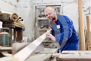 Worker at wood processing manufactory