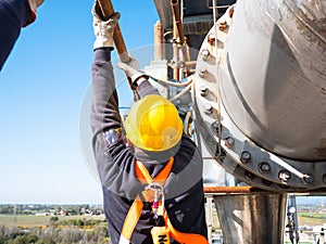 Worker at work at height with personal protective equipment photo