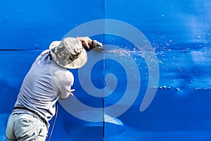 Worker working by Electric grinder industry tool cutting blue steel sheet to repair and Change new metal sheet , Selective focus