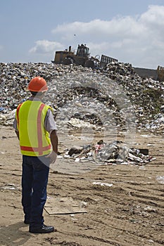 Worker Working At Landfill Site