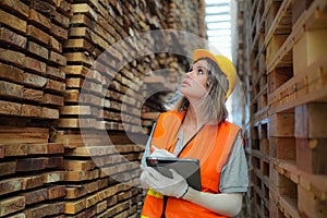 Worker are working at lumber yard in Large Warehouse.