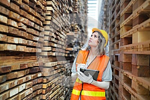 Worker are working at lumber yard in Large Warehouse.