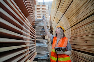 Worker are working at lumber yard in Large Warehouse.