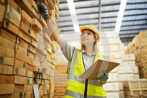 Worker are working at lumber yard in Large Warehouse.