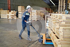 Worker are working at lumber yard in Large Warehouse.