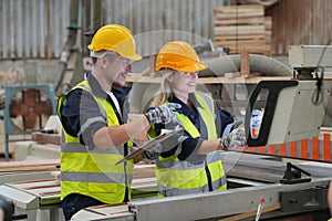 Worker are working at lumber yard in Large Warehouse.