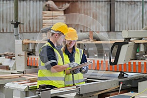 Worker are working at lumber yard in Large Warehouse.