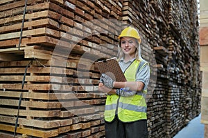 Worker are working at lumber yard in Large Warehouse.