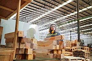 Worker are working at lumber yard in Large Warehouse.