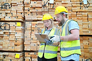 Worker are working at lumber yard in Large Warehouse.