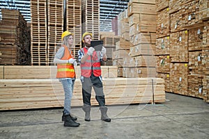 Worker are working at lumber yard in Large Warehouse.