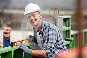 worker working with spirit level at construction site