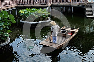 Worker is working on wood boat