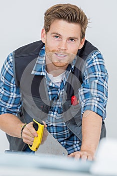 worker works with handsaw