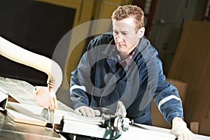 Worker at workshop with circ saw
