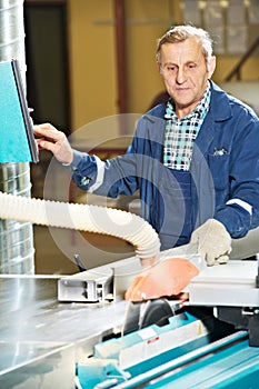 Worker at workshop with circ saw