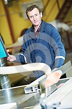 Worker at workshop with circ saw