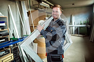 Worker in workshop for manufacture of windows and doors