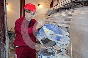 Worker at Workshop Operating Circular Saw