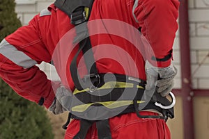 Worker in workwear. installer of the roof. safety belt on the worker