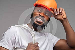 Worker with a wrapped cable over the shoulder looking away