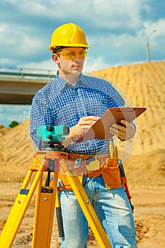 A worker writing with a ballpoint pen in clipboard