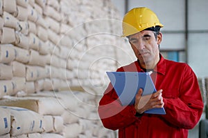 Worker Writing on Clipborad in Warehouse