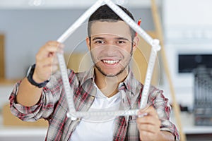 Worker with yardstick- house in front white background