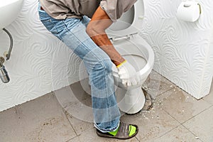 workerman performs repair of toilet bowl,