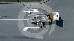 Workers apply road markings top view