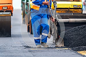 The workers and the asphalting machines