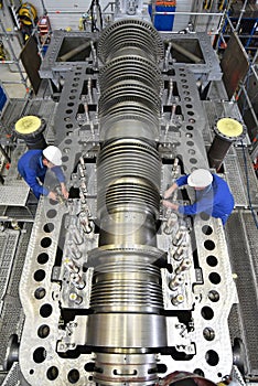 Workers assembling and quality control of gas turbines in a mode