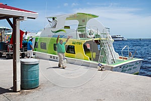 Workers of the `Belize water taxi` having fun at the harbor of Belize City