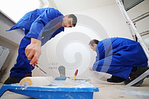 Workers in blue glue paint fiberglass and paint photo