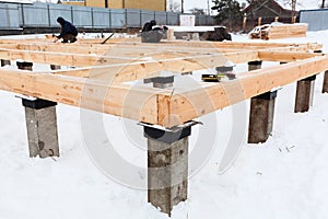 Workers build a timber house, framework beam