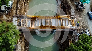 Workers building a bridge over a river