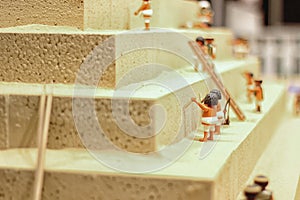 Workers building a pyramid