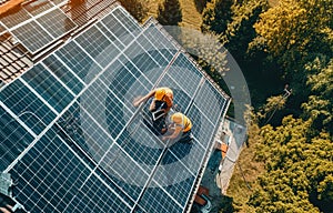 Workers building solar panel system on roof of house