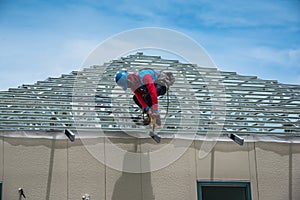 Workers are building a steel roof frame on high.