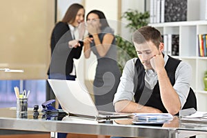 Workers bullying a colleague at office photo