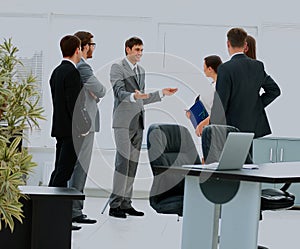 Workers at business meeting looking at presentation of financial reports in modern office.