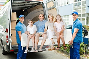 Workers Carrying Family With Sofa