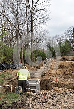 Workers Cementing Corner Catch Basins in Place, Vertical