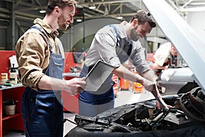 Workers Checking Car in Service