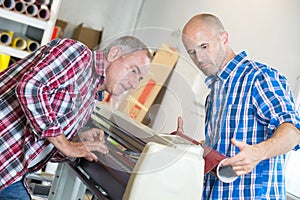 Workers checking printer format inkjet working